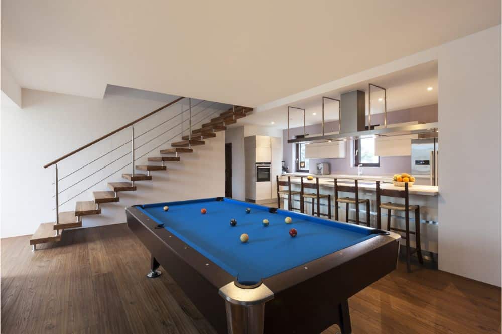 man cave with billiard table and bar