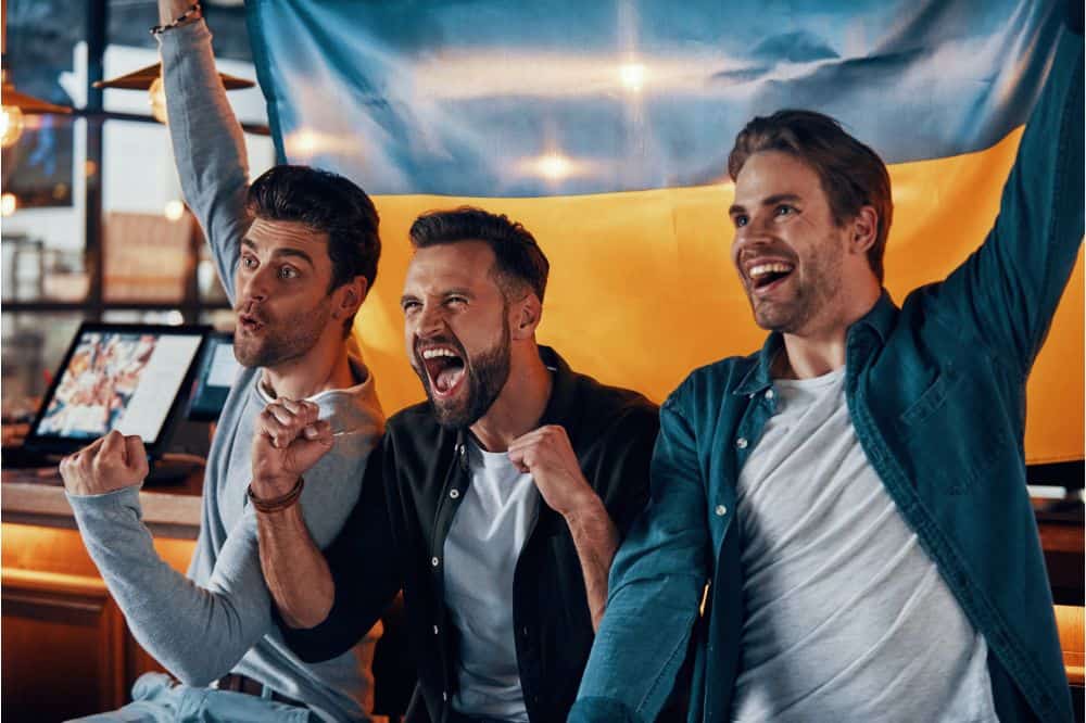Three cheering young men