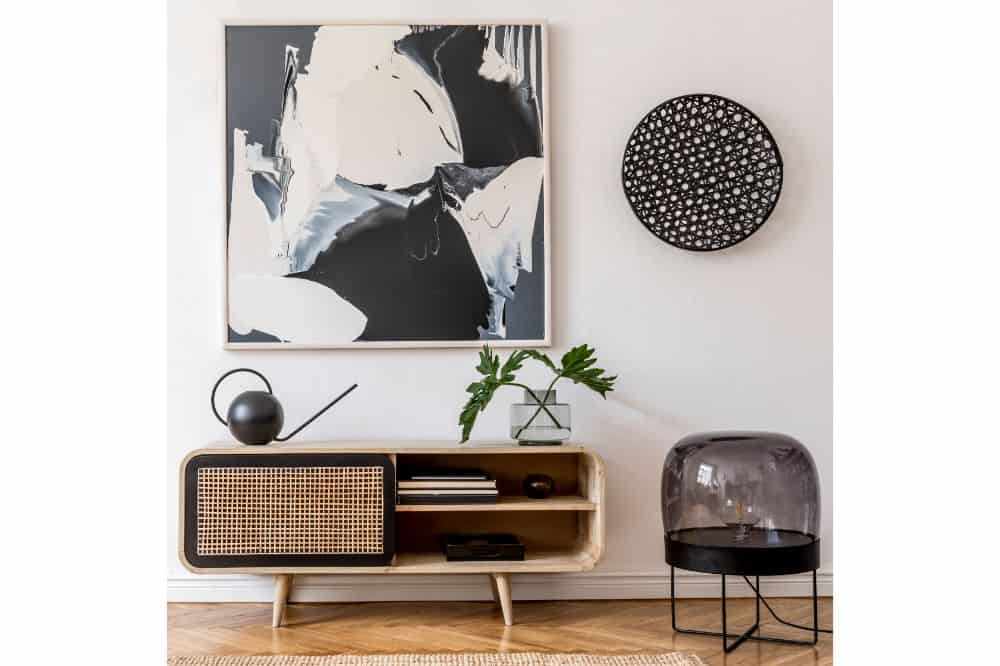 Mock up poster paintings with wooden commode, black lamp, tropical leafs