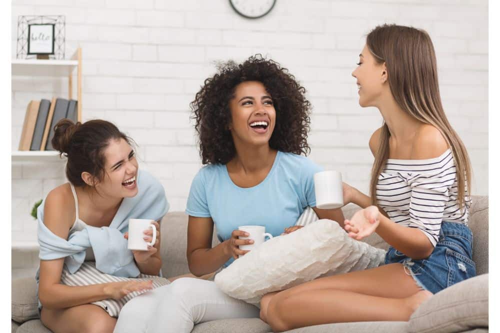 girls drinking tea and chatting at home