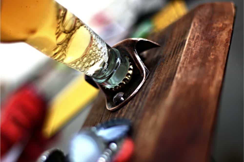 opening beer bottle on wall bottle opener